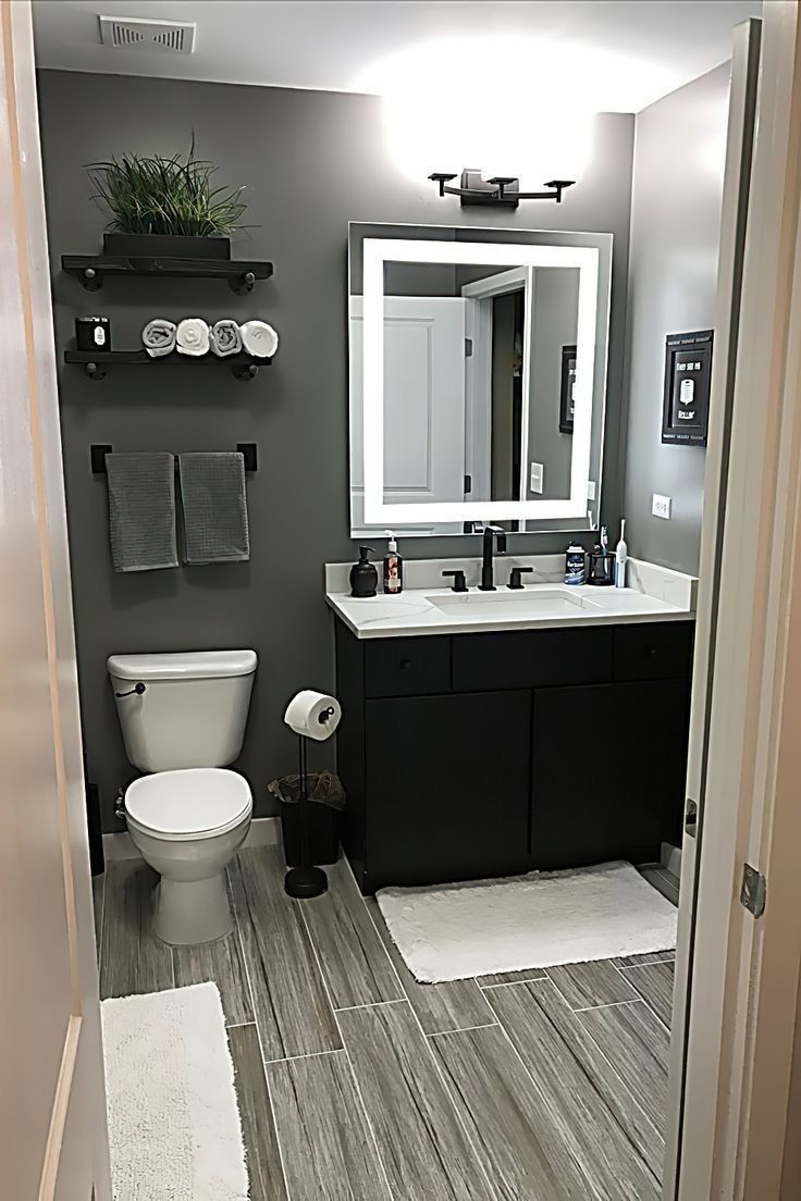 Modern bathroom renovation by Danish Jafri Bathroom Designs with black vanity, LED mirror, and grey interior finishes